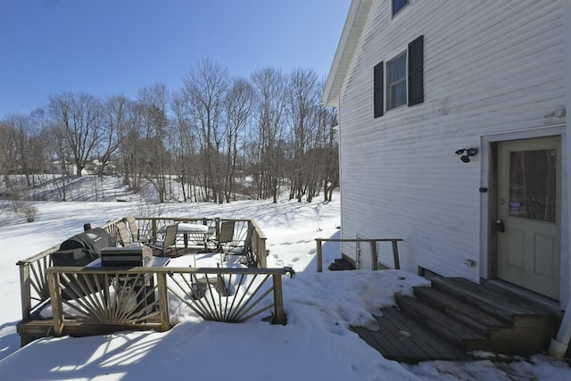 snow covered deck with entry steps