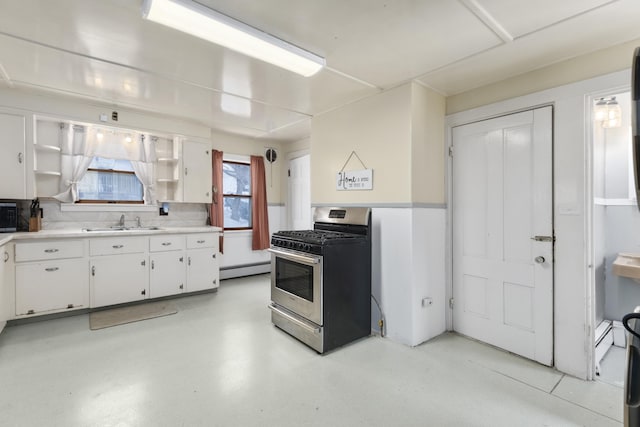 kitchen featuring a sink, white cabinets, light countertops, open shelves, and gas stove