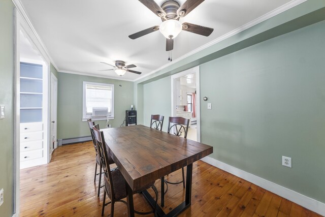 dining room with a baseboard radiator, light wood-style flooring, ornamental molding, cooling unit, and baseboards