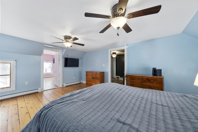 bedroom featuring baseboards, a ceiling fan, lofted ceiling, hardwood / wood-style flooring, and a baseboard heating unit