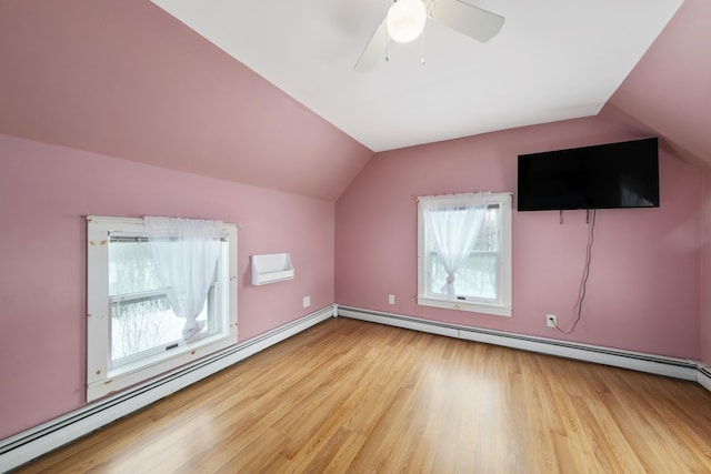 additional living space with lofted ceiling, ceiling fan, a baseboard radiator, and light wood-style flooring