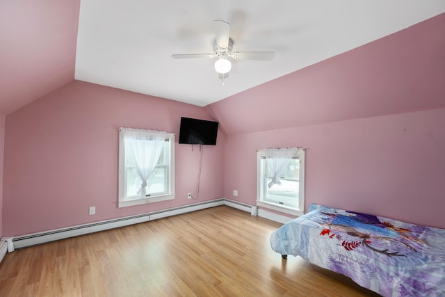 bedroom featuring a baseboard radiator, vaulted ceiling, and wood finished floors