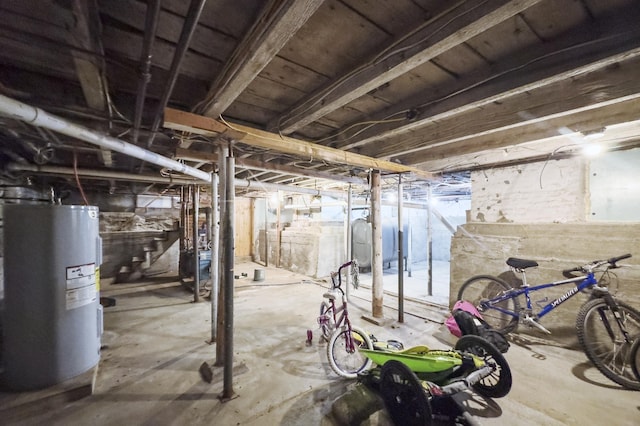 unfinished basement with water heater and heating fuel