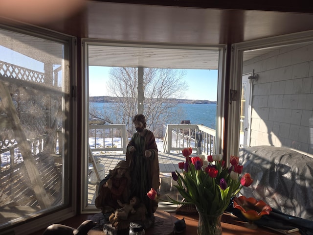 interior space with a water view and concrete block wall