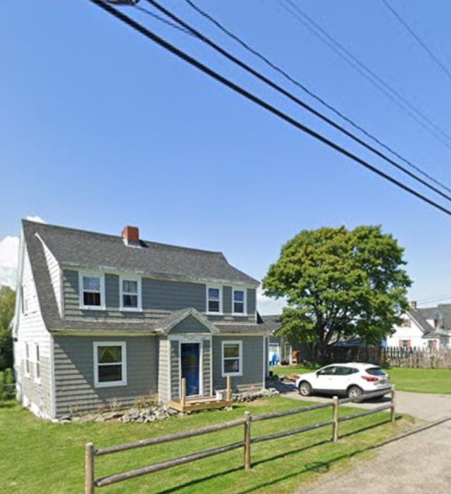 view of front of home with a front lawn and a fenced front yard