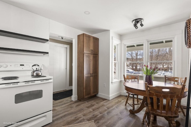 kitchen featuring light countertops, white electric range, brown cabinetry, wood finished floors, and baseboards