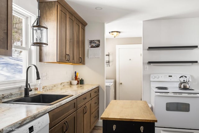 kitchen featuring butcher block counters, decorative backsplash, a kitchen island, a sink, and white appliances