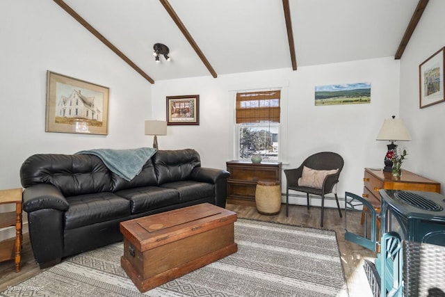 living area featuring lofted ceiling with beams, a baseboard heating unit, and wood finished floors