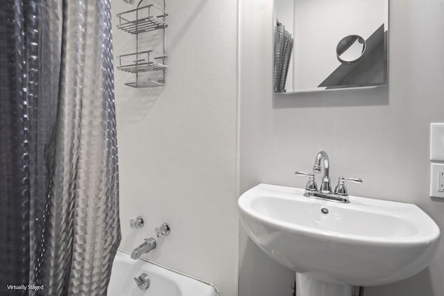 bathroom featuring shower / bath combo and a sink