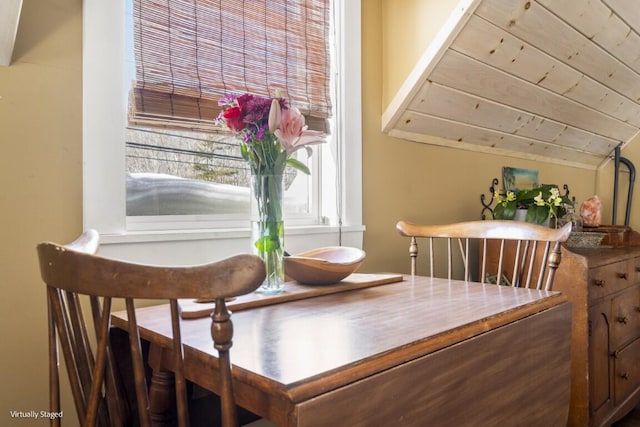 dining space featuring wooden ceiling and vaulted ceiling