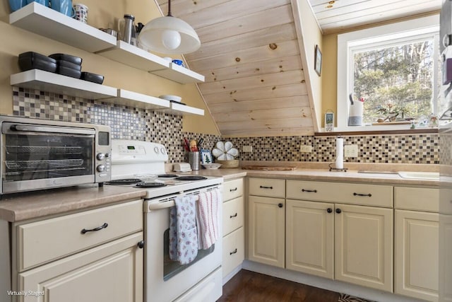 kitchen with electric stove, light countertops, and open shelves