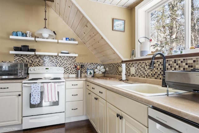 kitchen with white appliances, a sink, wood ceiling, vaulted ceiling, and light countertops