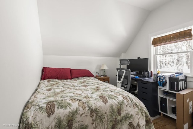 bedroom with lofted ceiling and dark wood-style flooring