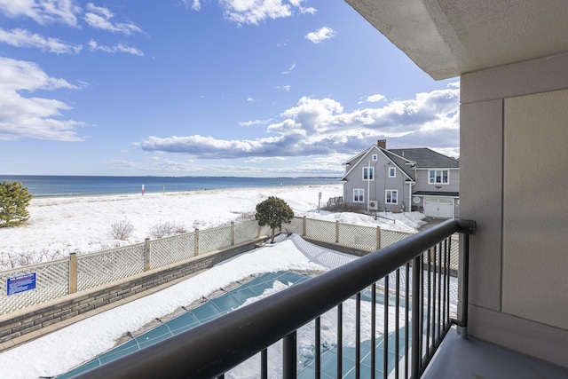 balcony featuring a water view and a view of the beach