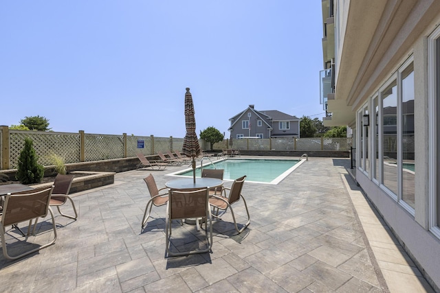 view of pool featuring a patio, a fenced backyard, and a fenced in pool