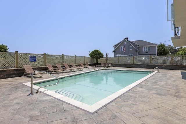 pool featuring a patio area and fence