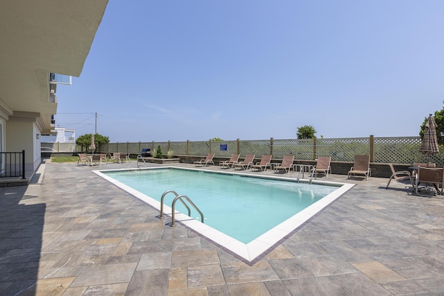 community pool featuring a patio area and fence