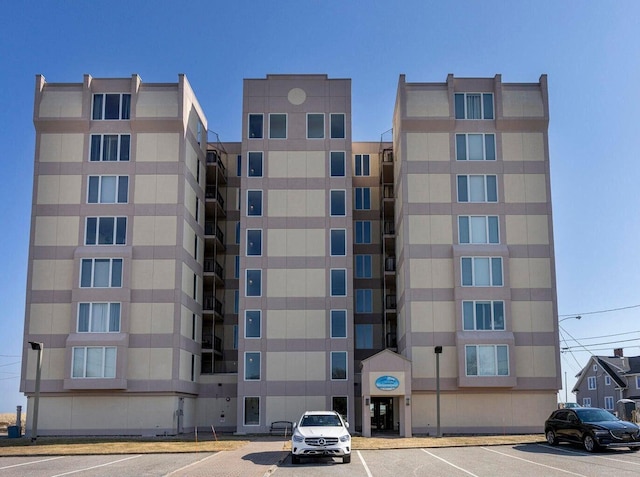 view of building exterior featuring uncovered parking