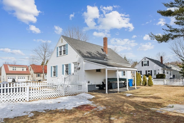 back of house with a shingled roof, fence, and a chimney