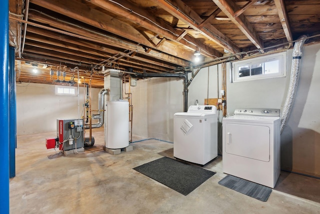 basement with a heating unit and separate washer and dryer