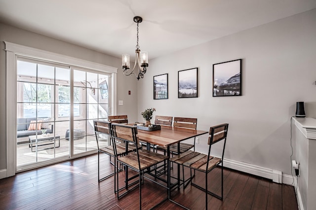 dining area with an inviting chandelier, baseboards, dark wood-type flooring, and a baseboard heating unit