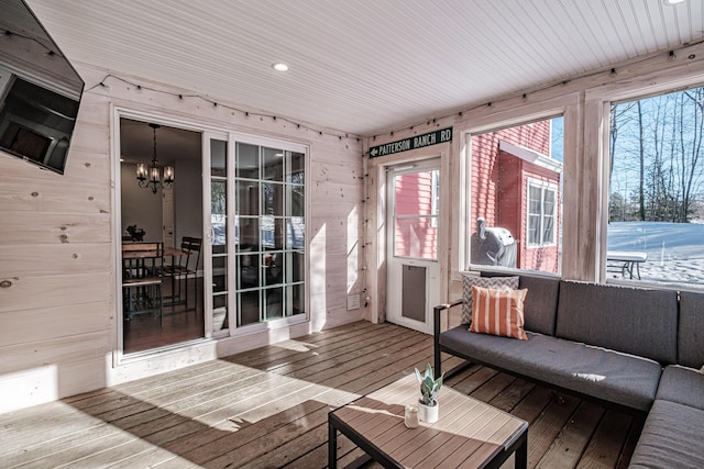 sunroom featuring a chandelier