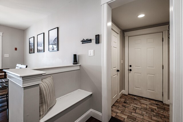 entryway featuring brick floor and recessed lighting