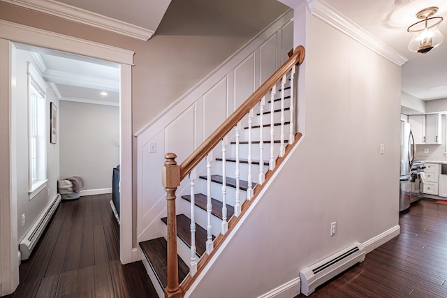 stairs with hardwood / wood-style floors, baseboards, a baseboard heating unit, and crown molding