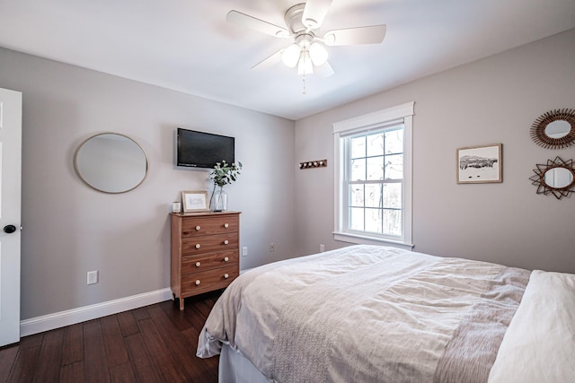 bedroom featuring ceiling fan, dark wood-style flooring, and baseboards