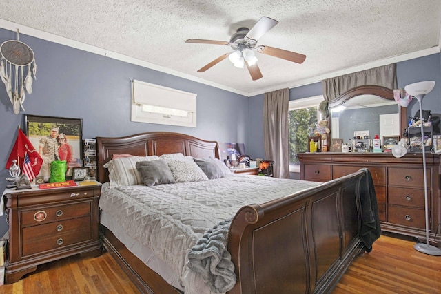 bedroom featuring crown molding, a textured ceiling, ceiling fan, and wood finished floors