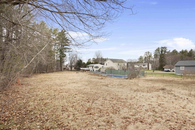 view of yard with fence and a fenced in pool
