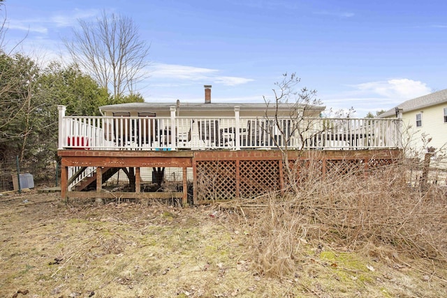 back of property featuring stairway and a wooden deck