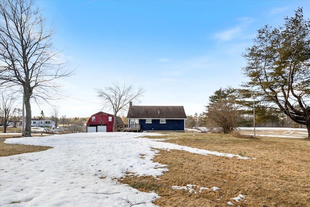 exterior space featuring a garage and an outbuilding