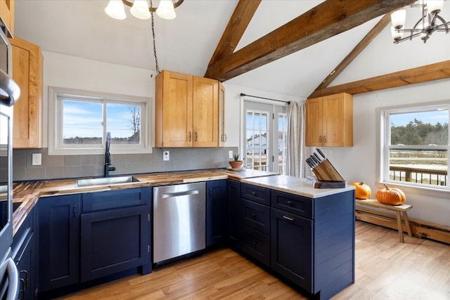 kitchen featuring a peninsula, vaulted ceiling with beams, a sink, dishwasher, and a notable chandelier