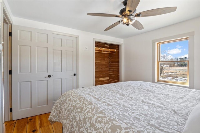 bedroom with ceiling fan and light wood-style flooring