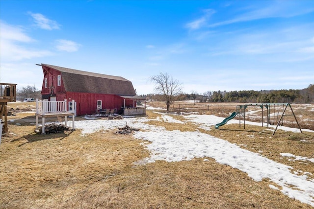 view of yard with a barn, an outdoor structure, and a playground