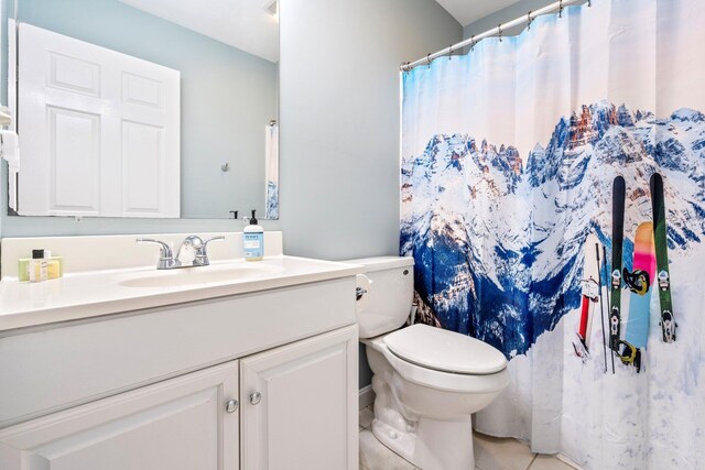full bathroom featuring a shower with curtain, vanity, toilet, and tile patterned floors