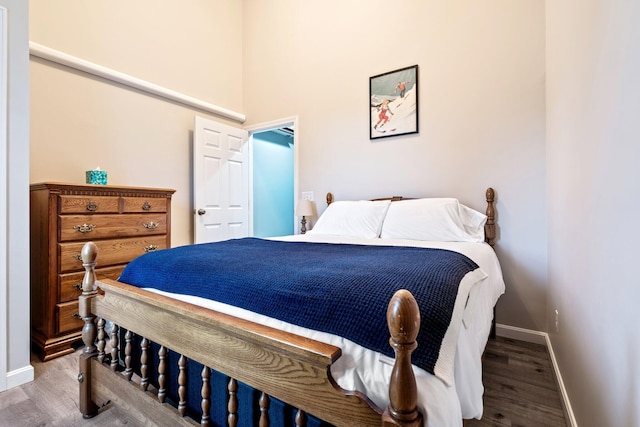 bedroom featuring baseboards and wood finished floors