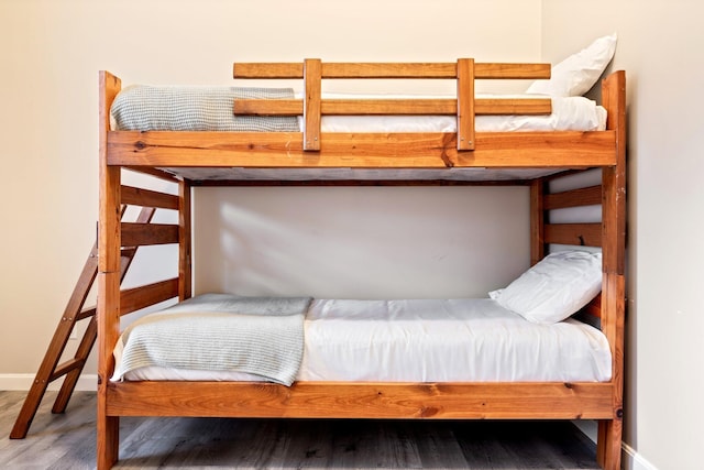 unfurnished bedroom featuring baseboards and wood finished floors