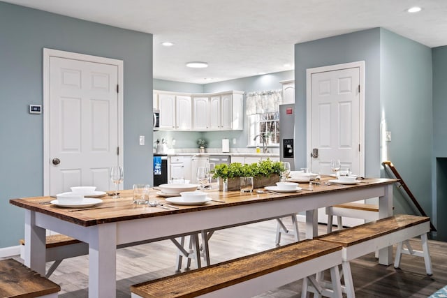 dining space featuring recessed lighting, baseboards, and wood finished floors