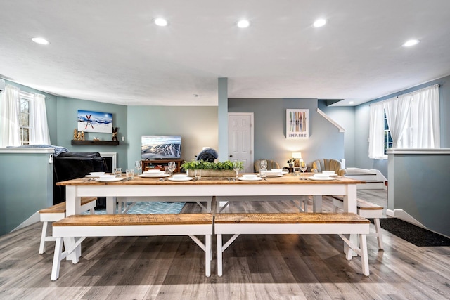 dining space with wood finished floors, a wealth of natural light, and recessed lighting