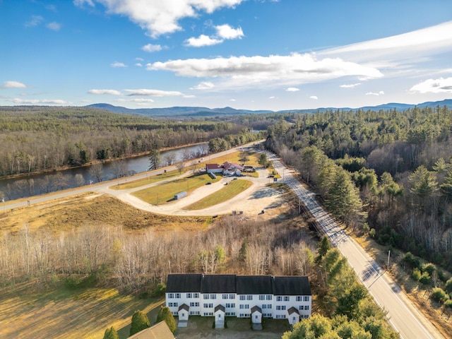 drone / aerial view featuring a forest view and a water and mountain view
