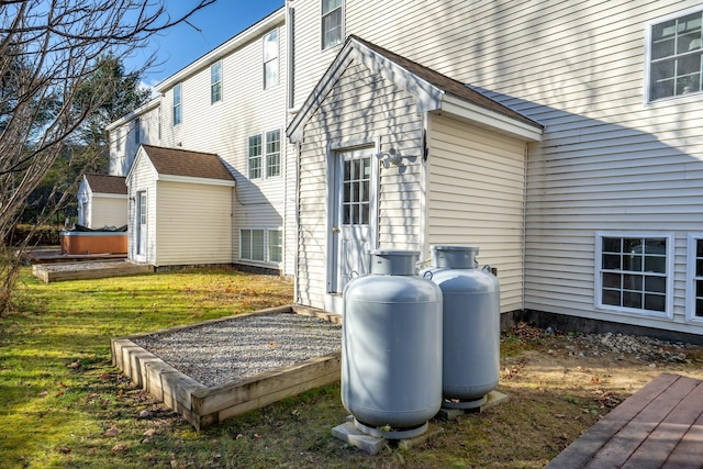 view of property exterior with an outbuilding and a yard