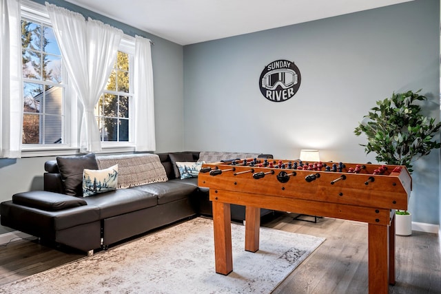 game room featuring baseboards and wood finished floors