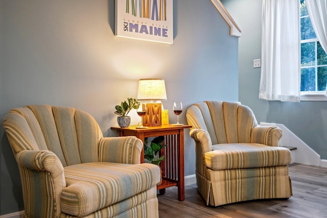 living area featuring baseboards and wood finished floors