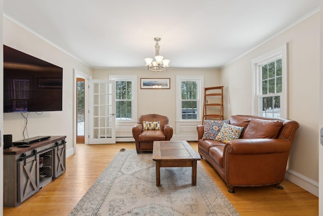 living room with ornamental molding, light wood finished floors, and a wealth of natural light