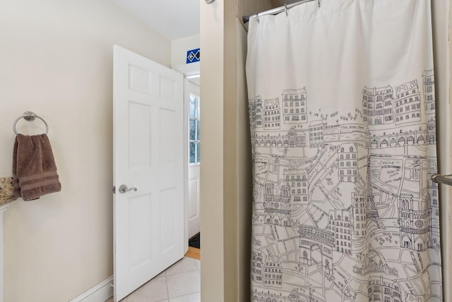 full bathroom with curtained shower and tile patterned floors