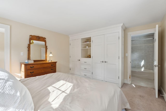 bedroom featuring light carpet and two closets