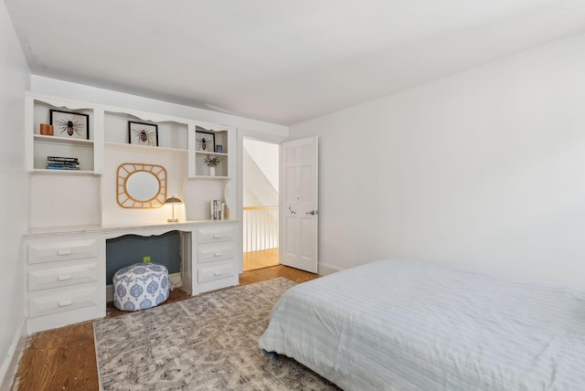 bedroom featuring baseboards and wood finished floors