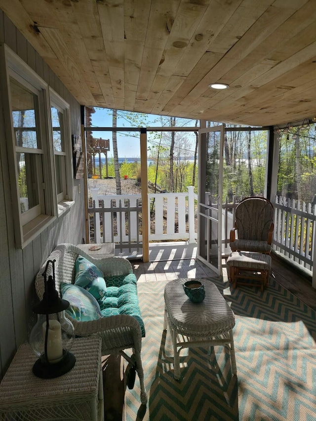 sunroom featuring wooden ceiling